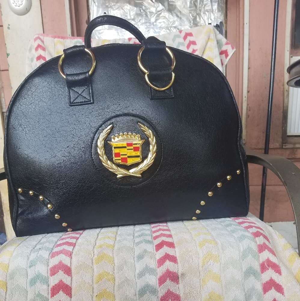 Black leather with gold accents weekender bag
